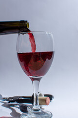 Pour red wine from the bottle into the glass