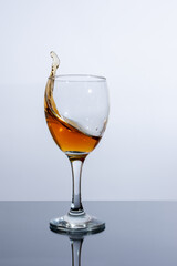A splash of cognac in a glass on the table