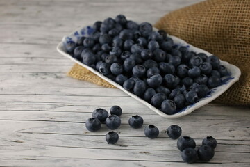 Blueberries in a bowl on the wooden table