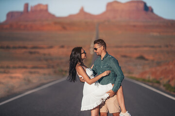 Happy couple on the famous road to Monument Valley in Utah. Amazing view of the Monument valley.