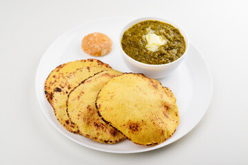 Saag with makki roti in plate on white background