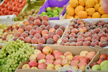 Different fresh fruits on the counter in the outdoors market.
