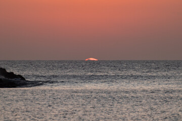 sequence of a sunset on Isla El Alacr&aacute;n, Arica City, northern Chile, with a sailboat on the right side