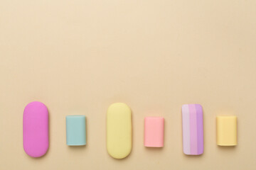 Colorful eraser on color backgroung, top view