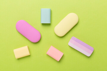 Colorful eraser on color backgroung, top view
