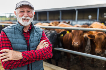 Farmer standing in front of cattle ranch