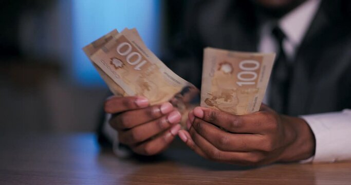 Close up shot on African American hands newly minted millionaire, feeling a surge of elation as he counts his newfound wealth, representing a lifetime of aspirations achieved.