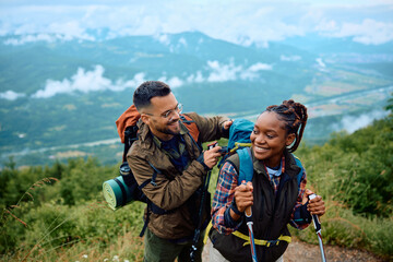 Happy couple of hikers spending day in mountains.