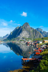 Perfect reflection of the Reine village on the water of the fjord in the Lofoten Islands,  Norway