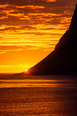 Incredible midnight sunset over the sea of Vik beach, Lofoten Islands,  Norway