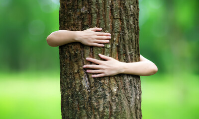 Conceptual idea: love of nature. A person hugging a tree. Close up on the affectionate hug.