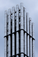 group of metal chimneys on a factory