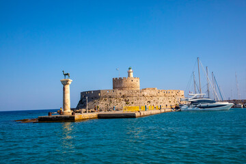 Landscape with Mandraki Harbour and two statues, Elefos and Elafina in Rhodes Island, Greece