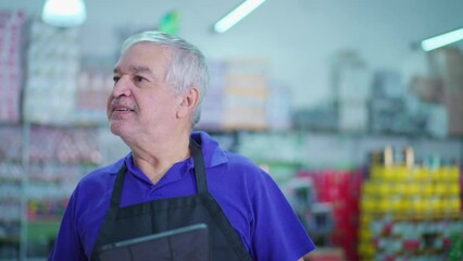 Male Caucasian Senior Manager of Grocery Store Using Tablet Device to Inspect Product Inventory on Supermarket Shelf