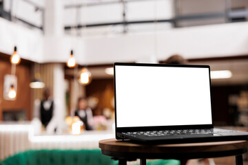 Laptop show isolated white display in lounge area at hotel reception, mockup template in lobby....