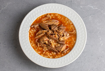 Turkish Soup Beyran with Lamb Meat, Rice, Chopped Garlic and Vinegar Sauce. Traditional Organic Food. Traditional soup of Gaziantep, Turkey. (Turkish name; Beyran corbasi)