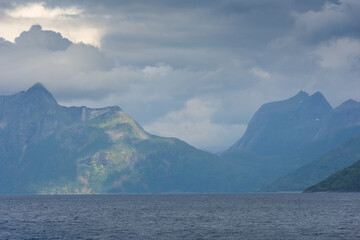 Fototapeta na wymiar Beautiful view over a Norwegian fjord from the sea