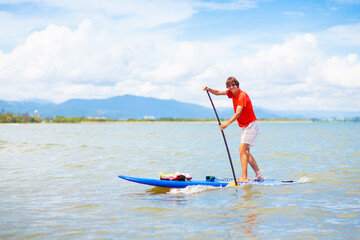 Man on stand up paddle. Water and beach sport