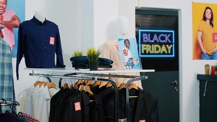 Promotional sales advertisement in store, price tags on clearance items indicating discounts. Attract clients during black friday event at shopping center, banners at front door.