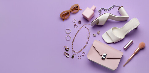 Set of stylish female accessories on lilac background with space for text