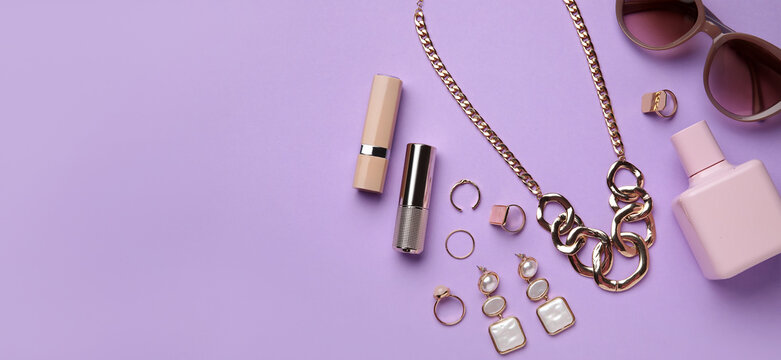 Set of stylish female accessories on lilac background with space for text