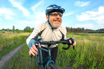 bearded man cyclist rides a bike on a road in nature. sports, hobbies and entertainment for health