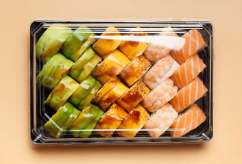Set of sushi rolls in plastic packages on a light background, top view.