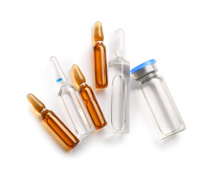 Glass medical ampules and bottle with medicines on white background