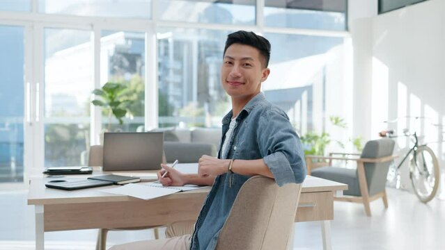 Face, happy man and creative writer in office, startup company or workplace on table. Portrait, author and smile of Asian professional, entrepreneur and employee from Japan with career in business.