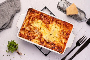 Food photography of lasagna, quiche, casserole, cheese, tomato sauce, parmesan, plate, towel, stand, ground rustic, italian food, pasta, bolognese