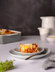 Food photography of lasagna, quiche, casserole, cheese, tomato sauce, parmesan, plate, towel, stand, ground rustic, italian food, pasta, bolognese