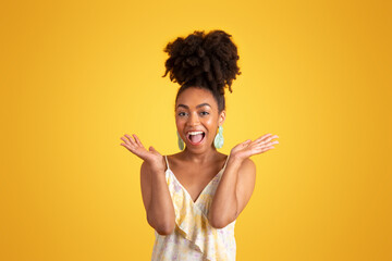Glad excited shocked millennial african american lady in dress spreads arms to sides