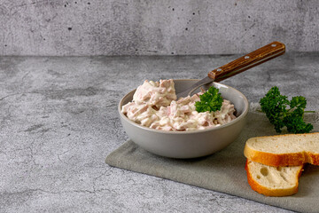 Meat salad in a gray bowl.