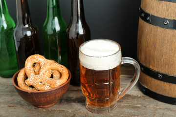 Mug of cold beer and pretzels on table. Oktoberfest celebration