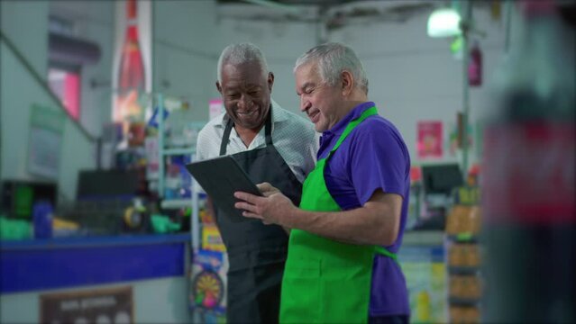 Senior Supermarket Employees with Tablet Device, Teamwork Scene of Older Manager Instructing Colleague