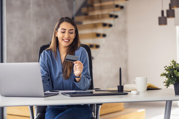 Young woman shopping online from modern office