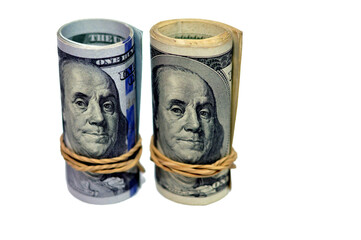 Rolls of 100 one hundred dollar banknote currency cash money old and new series rolled up with...