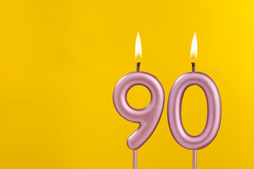 Birthday candle number 90 - Birthday celebration on yellow background