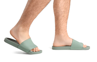 Male legs in flip-flops on white background