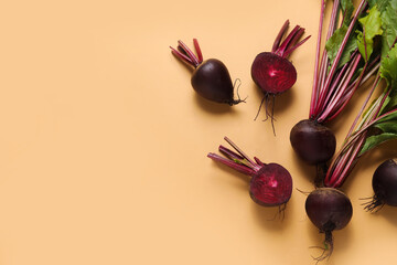 Fresh beets with green leaves on beige background