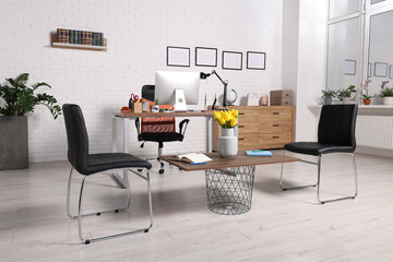 Stylish director's workplace with comfortable furniture and waiting area in office. Interior design