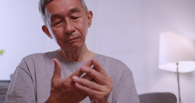 An elderly man's hand is trembling because of Parkinson's disease.
