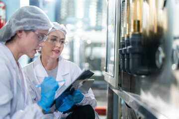 scientist worker checking the quality of the Reverse osmosis machine system at the industrial factory. Female worker recording data at the control panel with measure tube for recycle portable plant.