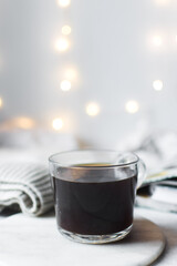 Selective focus on a glass cup with coffee on a marble tray