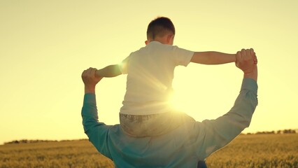 man father play with his son child airplane. family game airplane pilot. dream childhood dad. little kid child boy with his father plays airplane pilot sunset wheat field. little son walks field with