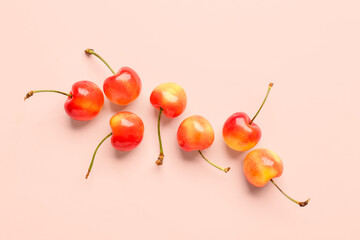 Obraz na płótnie Canvas Many sweet yellow cherries on pink background