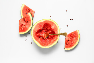 Half of fresh watermelon with pieces and seeds on white background