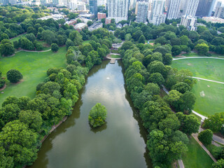 aerial shot of the green waters of Lake Clara Meer surrounded by lush green trees, grass and plants...