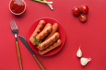 Plate with tasty grilled sausages and sauce on red background
