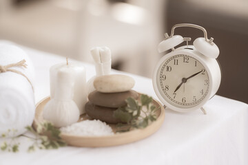 Concept, time to prepare for spa. Beautiful spa composition with alarm clock